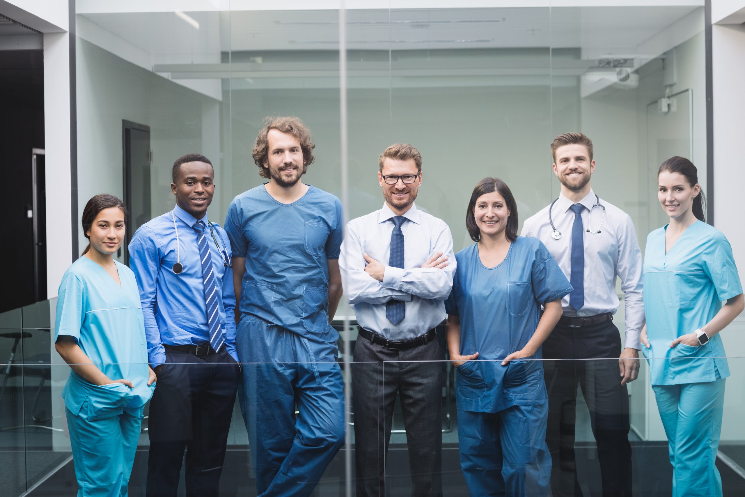 Portrait of smiling doctors standing together in corridor at hospital